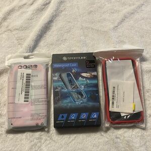 2 red iPhone cases and 1 black waterproof case. Brand new